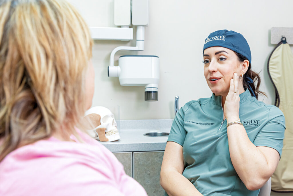 A provider holds her fingers to her chin as she explains Botox for TMJ in Craven County.