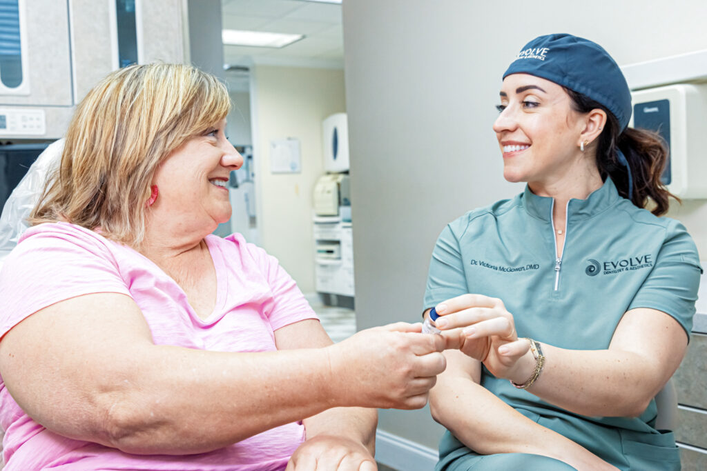 A provider smiles and shows a patient the benefits of TMJ treatment in Craven County.