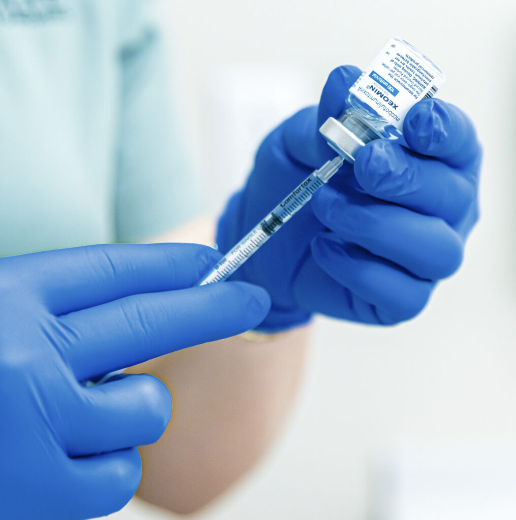 A provider wearing surgical gloves while injecting Botox for TMJ near Trent Woods.